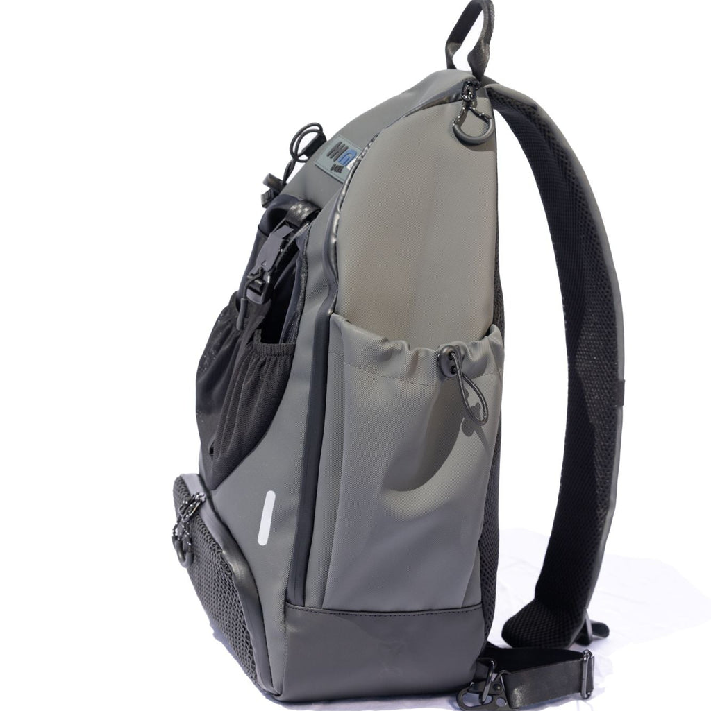 Grey BORA sports bag, side view showing the drawstring bottle pocket and adjustable shoulder strap