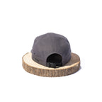 Black BORA cap, rear view showing the adjustable black strap and buckle