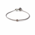 Grey BORA cord bracelet with a central spiral-symbol bead and adjustable sliding knot
