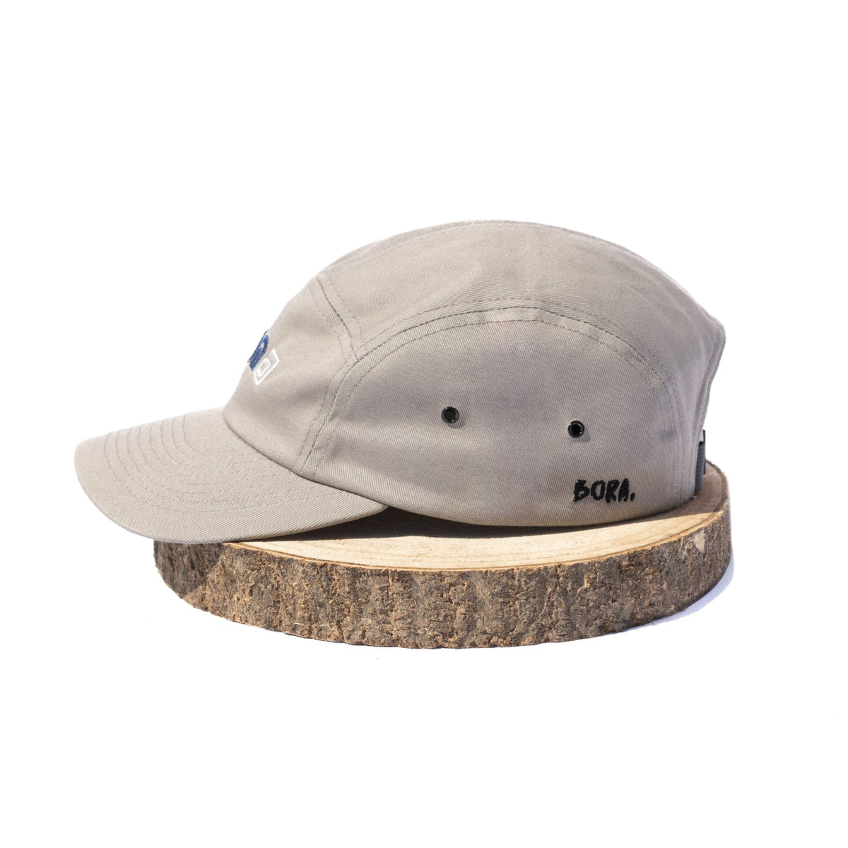 Grey BORA cap, side view showing ventilation eyelets and embroidered BORA logo