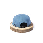 Blue BORA cap, rear view showing the adjustable black strap and buckle