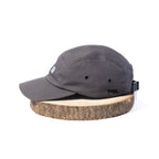 Black BORA cap, side view showing ventilation eyelets and embroidered BORA logo