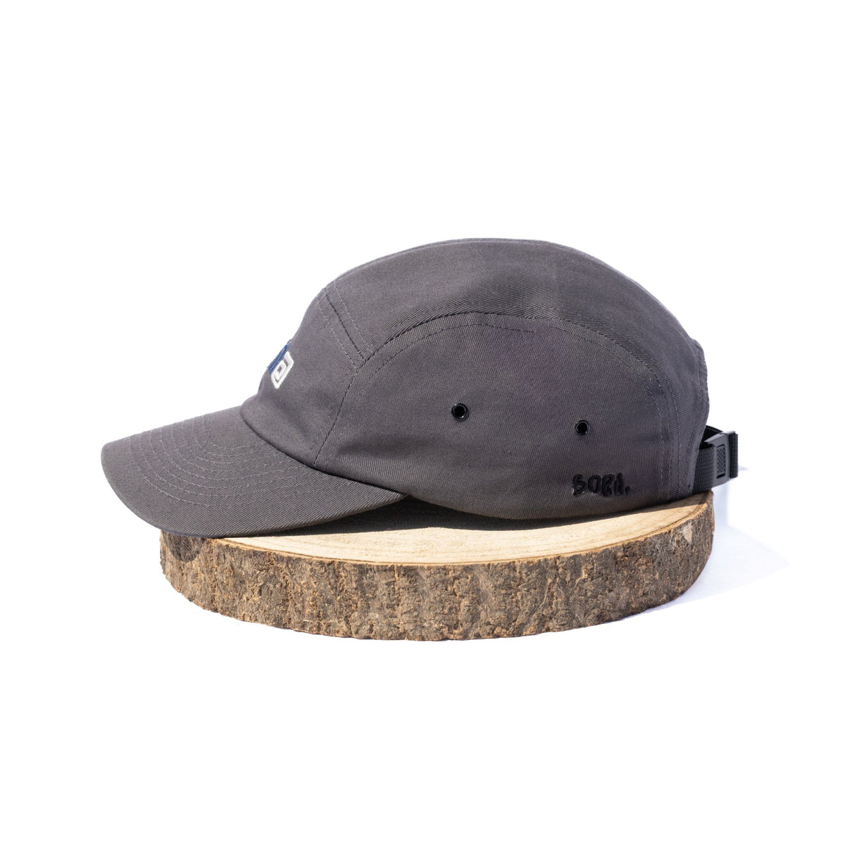 Black BORA cap, side view showing ventilation eyelets and embroidered BORA logo